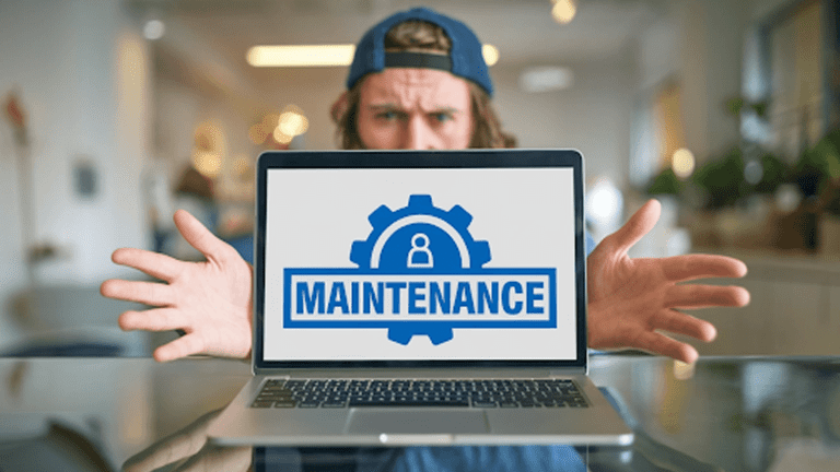 A-guy-with-a-laptop-showing-Maintenance,-emphasizing-the-importance-of-website-maintenance-services.