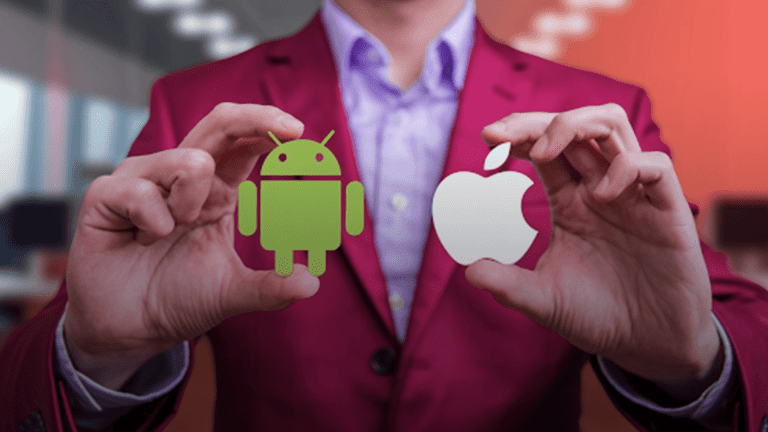 A-man-in-a-suit-displays-two-icons,-representing-Android-vs-iOS-development,-highlighting-the-tech-rivalry