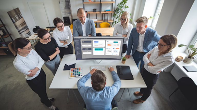 UI-UX-designer-working-on-a-project-with-team-members-collaborating-around-in-a-modern-office-environment