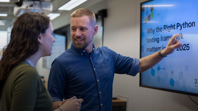 A-man-is-presenting-a-slide-about-Python-testing-frameworks-in-2025-to-a-colleague